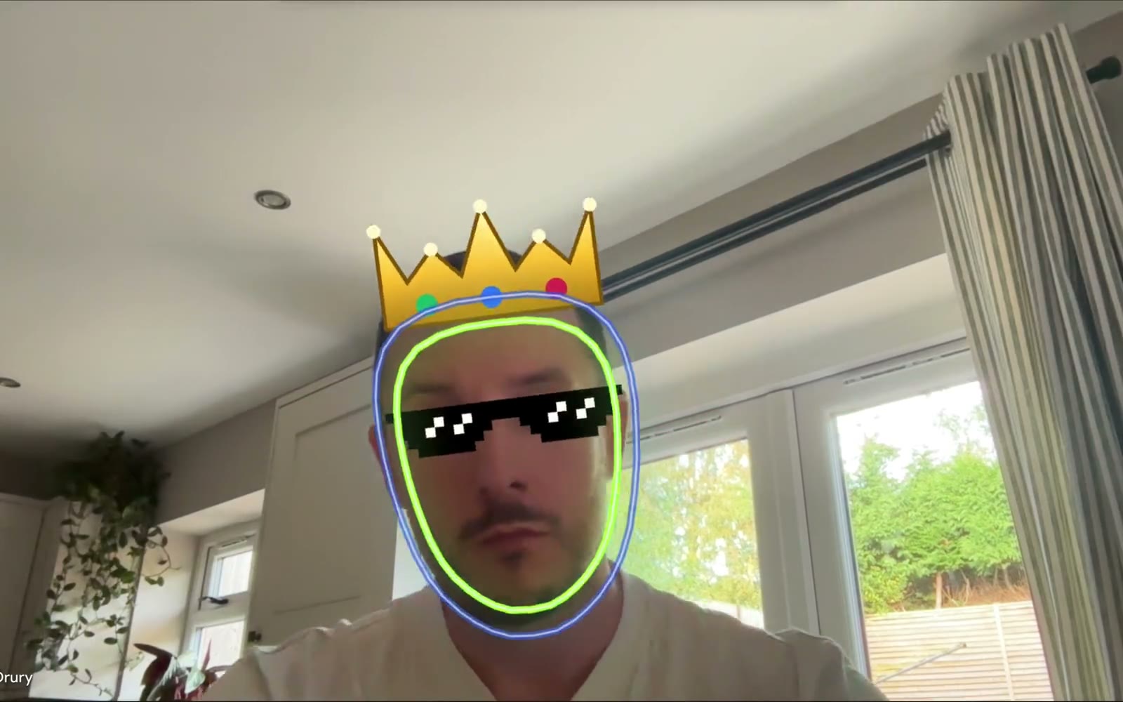 A crown, deal-with-it shades and a neon face outline tracking Chris's face