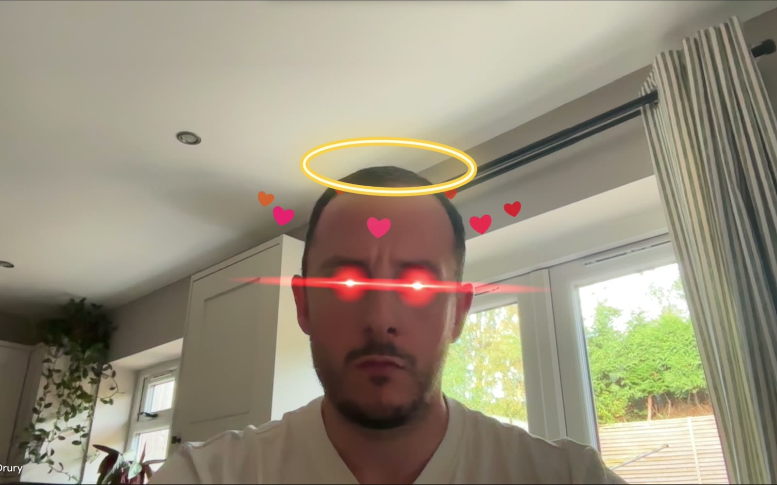 Halo, laser eyes and hearts orbiting Chris's head on a Meet call