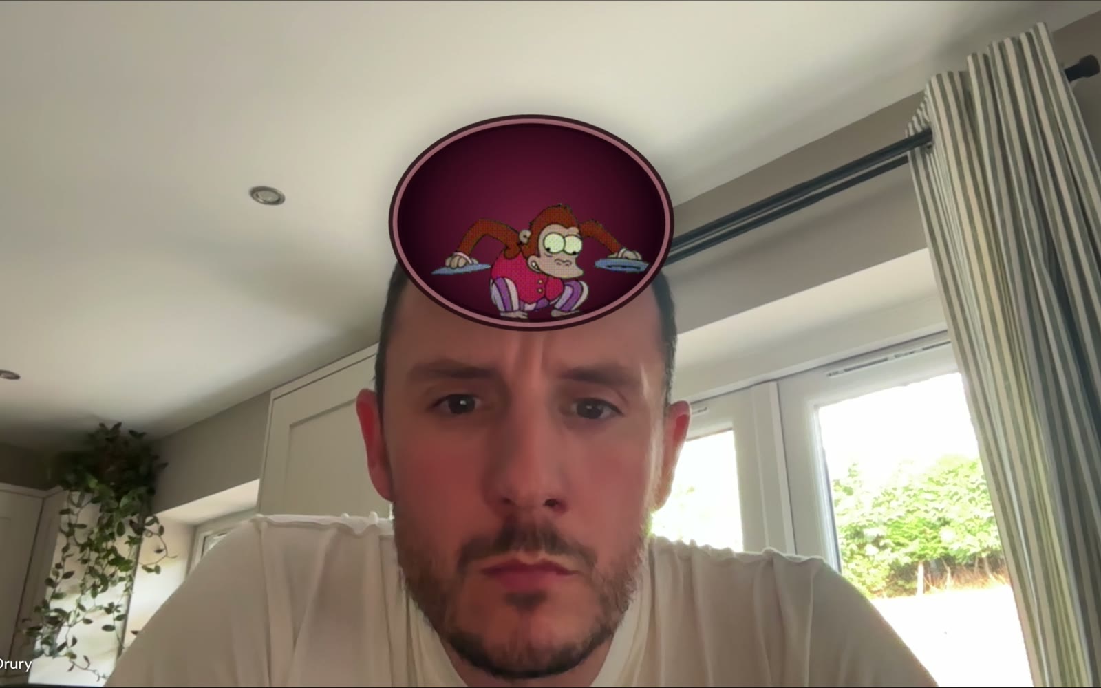 An animated cymbal-monkey GIF pinned above Chris's head