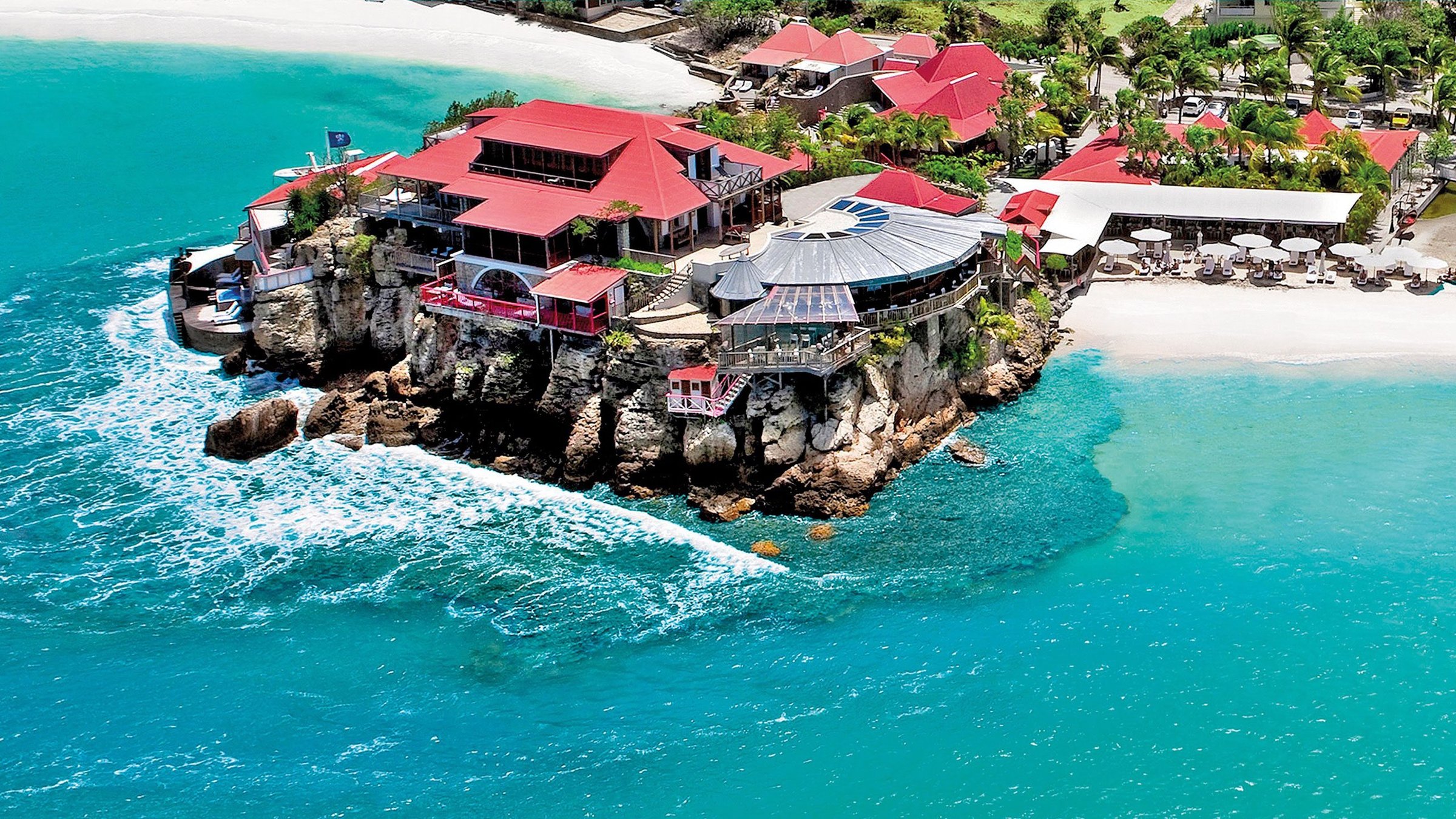 Eden Rock hotel on its rocky headland in turquoise water